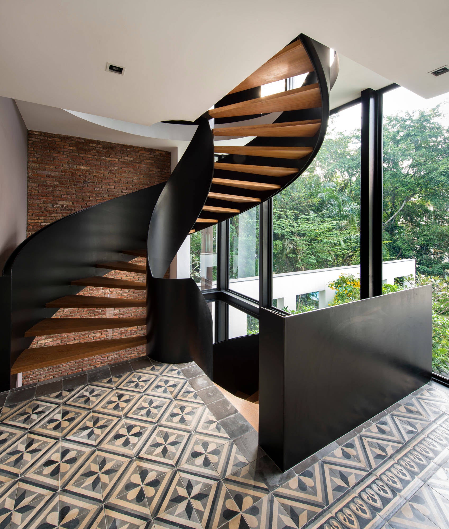 Curved Staircase with Black steel Railing and wooden tread design